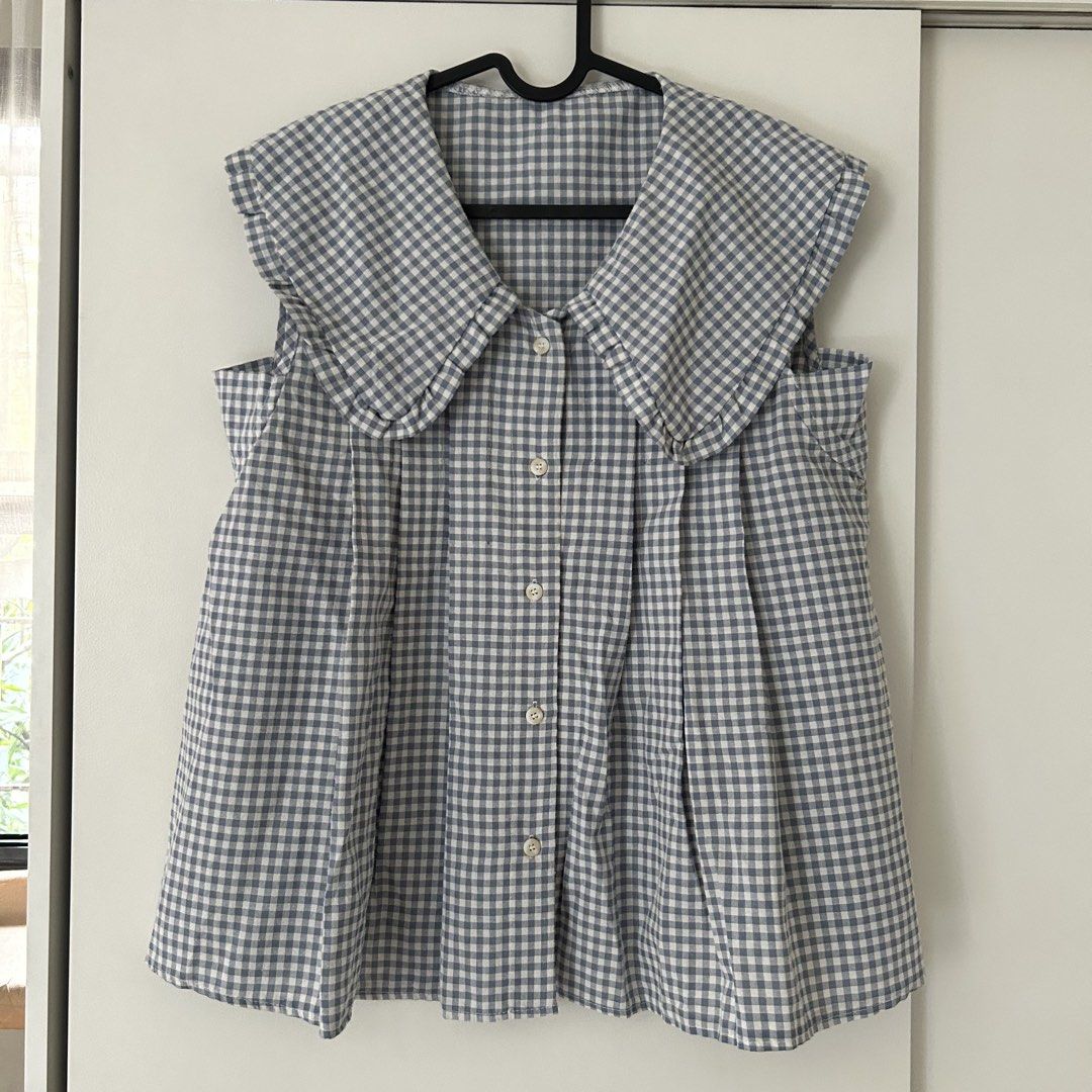Gingham Sleeveless Top with Peter Pan Collar (Category: Blouses) located in Quezon City. Submitted by p0lingkit (Listing ID 1432080994, Image 1). Description: - Sleeveless gingham top - Classic blue and white pattern - Peter Pan collar - Button-down front - Lightweight fabric - Relaxed fit.