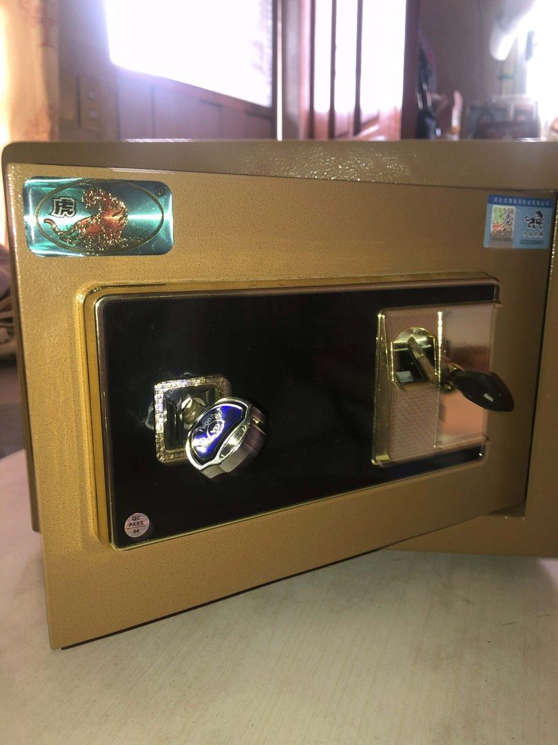 Gold Safe with Fingerprint Lock Fireproof (Category: Safe) located in Caloocan City. Submitted by beyasclothing (Listing ID 1432017751, Image 2). Description: Gold-colored safe Fingerprint and key lock Patterned interior lining Includes a shelf Black panel Fireproof Negotiable Pm me for more details :))).