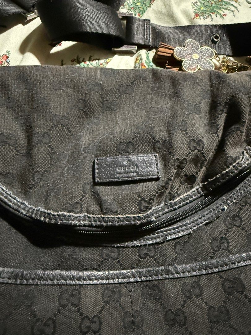 Gucci Diaper Bag Black GG Canvas (Category: Luxury Bags & Wallets) located in Taytay. Submitted by jayezapanta (Listing ID 1432191924, Image 3). Description: - Gucci diaper bag - Black GG canvas - Top flap closure - Adjustable shoulder strap - Multiple pockets for organization - Includes key ring with charms - Main compartment and small pocket inside - Made in Italy Walang zipper puller nilagyan ko na lang Fragile na ang leather trimmings pero ov