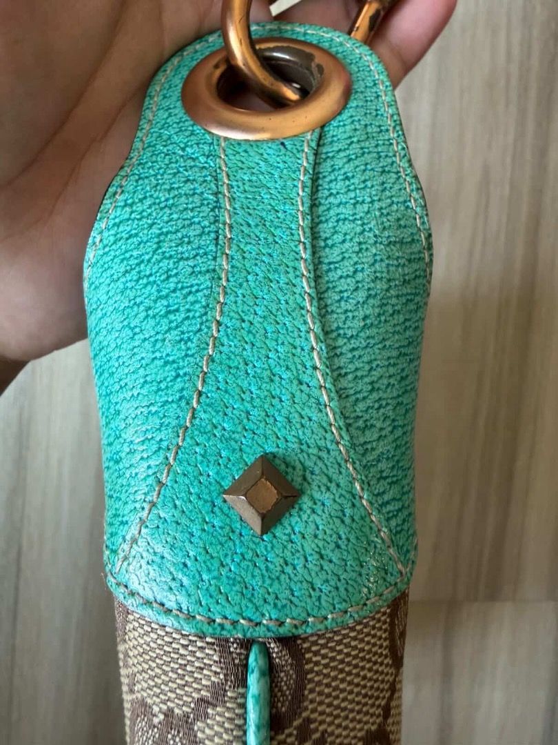 Gucci Jackie Piston Lock Hobo Bag (Category: Luxury Bags & Wallets) located in Taguig. Submitted by imeverywhereimsellahhhh (Listing ID 1432120942, Image 3). Description: - Authentic Gucci Jackie Hobo bag - Iconic GG canvas - Turquoise leather accents - Bamboo clasp - Single handle - Spacious interior - Hardware shows wear - Gucci logo visible.