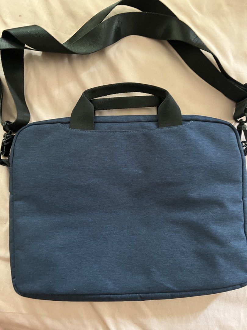 Halo Laptop Bag - Navy Blue (Category: Laptop Bags & Sleeves) located in Marikina City. Submitted by unniesonlinecloset (Listing ID 1432048708, Image 2). Description: - Navy blue laptop bag - Includes a detachable shoulder strap - Features a top handle - Has a zippered front pocket - Showcases the "Halo" logo - Made of textured fabric.