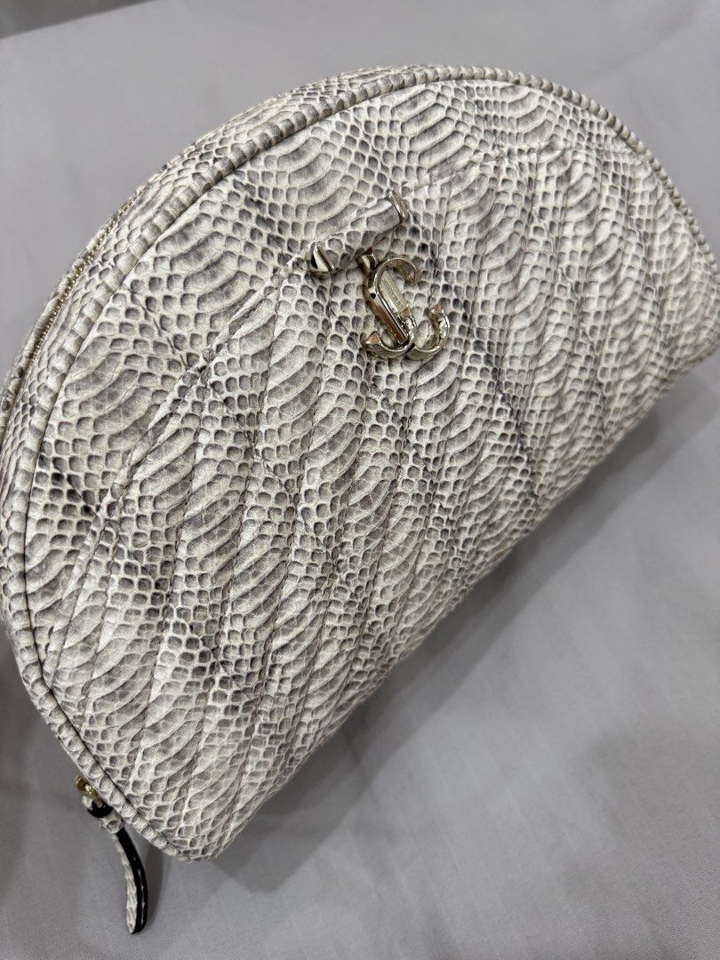 Jimmy Choo snakeskin-print leather pouch (Category: Purses & Pouches) located in Bulacan. Submitted by kallyseconds (Listing ID 1432036014, Image 1). Description: Avenue Quilted Snakeskin-Print Leather Pouch Jimmy Choo “Avenue” curve pouch in snakeskin-print leather with diagonal quilting Brand new With dust bag Zip top closure Front metal logo Interior, one slip pocket Lining: Leather Trim: Leather Approx. 6.7”H x 11.5”W x 2.8”D Weight: 0.65 lbs
