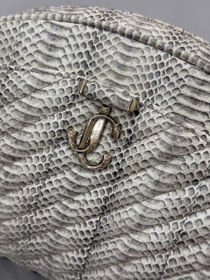Jimmy Choo snakeskin-print leather pouch (Category: Purses & Pouches) located in Bulacan. Submitted by kallyseconds (Listing ID 1432036014, Image 2). Description: Avenue Quilted Snakeskin-Print Leather Pouch Jimmy Choo “Avenue” curve pouch in snakeskin-print leather with diagonal quilting Brand new With dust bag Zip top closure Front metal logo Interior, one slip pocket Lining: Leather Trim: Leather Approx. 6.7”H x 11.5”W x 2.8”D Weight: 0.65 lbs