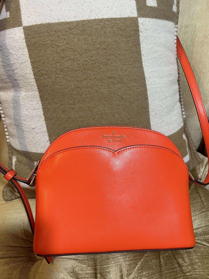 Kate Spade Orange Crossbody Bag (Category: Luxury Bags & Wallets) located in Las Pinas. Submitted by marivel17 (Listing ID 1432166357, Image 1). Description: - Bright orange Kate Spade crossbody bag - Zip closure - Heart-shaped design on front - Light-colored interior lining - Small interior pocket - Long strap for shoulder or crossbody wear - Authentic Kate Spade.