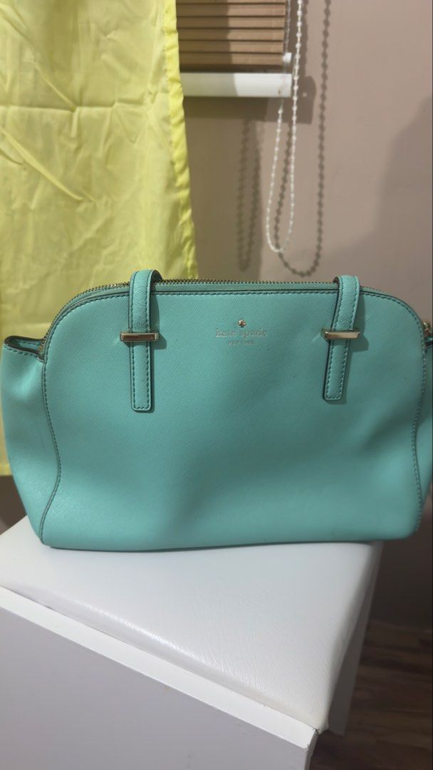 Kate Spade Satchel Handbag (Category: Shoulder Bags) located in Bulacan. Submitted by lovedthingsetc (Listing ID 1432136717, Image 2). Description: - Authentic Kate Spade handbag from the US - Light blue/teal color - Zip closure - Double handles - Spacious interior with pocket - Features the Kate Spade logo.