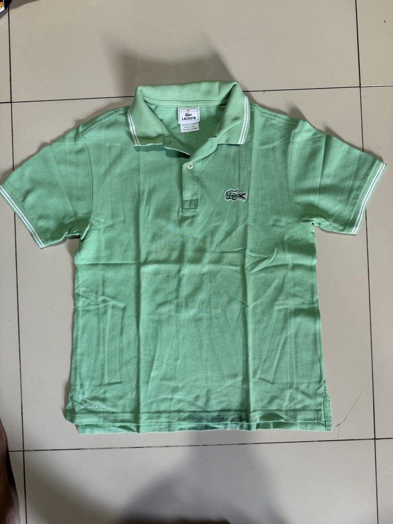 Lacoste Green Polo Shirt Size 14 (Category: Tshirts & Polo Shirts ) located in Caloocan City. Submitted by mochibolala13 (Listing ID 1432059657, Image 1). Description: Authentic Lacoste polo shirt in a refreshing green color. Features the iconic Lacoste crocodile logo on the chest. Made in Peru, designed in France. Size 14. Made of 100% cotton. The shirt has a classic polo collar and short sleeves with white trim..