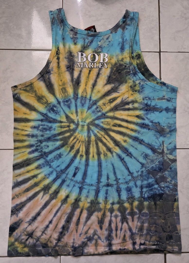 Lion King Bob Marley Tank Top - Large (Category: Activewear) located in Mandaluyong City. Submitted by arayko (Listing ID 1432014426, Image 2). Description: - Lion King tank top with vibrant tie-dye design. - Features a Bob Marley graphic on the front. - Tie-dye pattern on the back with Bob Marley logo. - Size: Large - Classic sleeveless design. Width- 19.5" Length- 28.5".