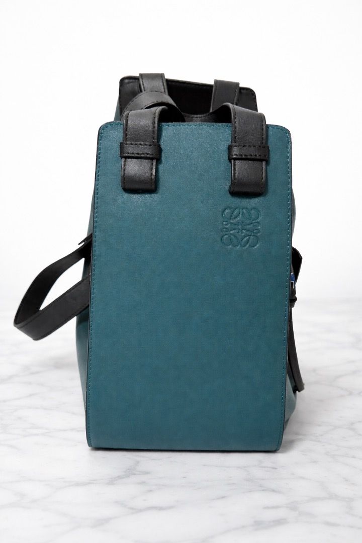 Loewe Hammock Bag (Category: Luxury Bags & Wallets) located in Cebu City. Submitted by theluxxaffair (Listing ID 1432073903, Image 2). Description: Loewe Hammock Bag in teal and black. Features a unique geometric design, top handle, detachable strap, pouch and zipper closures on the side. This luxury handbag known for its multifunctional design with side panels that fold in or out, changing its shape to suit different needs. Made in Spain. Height