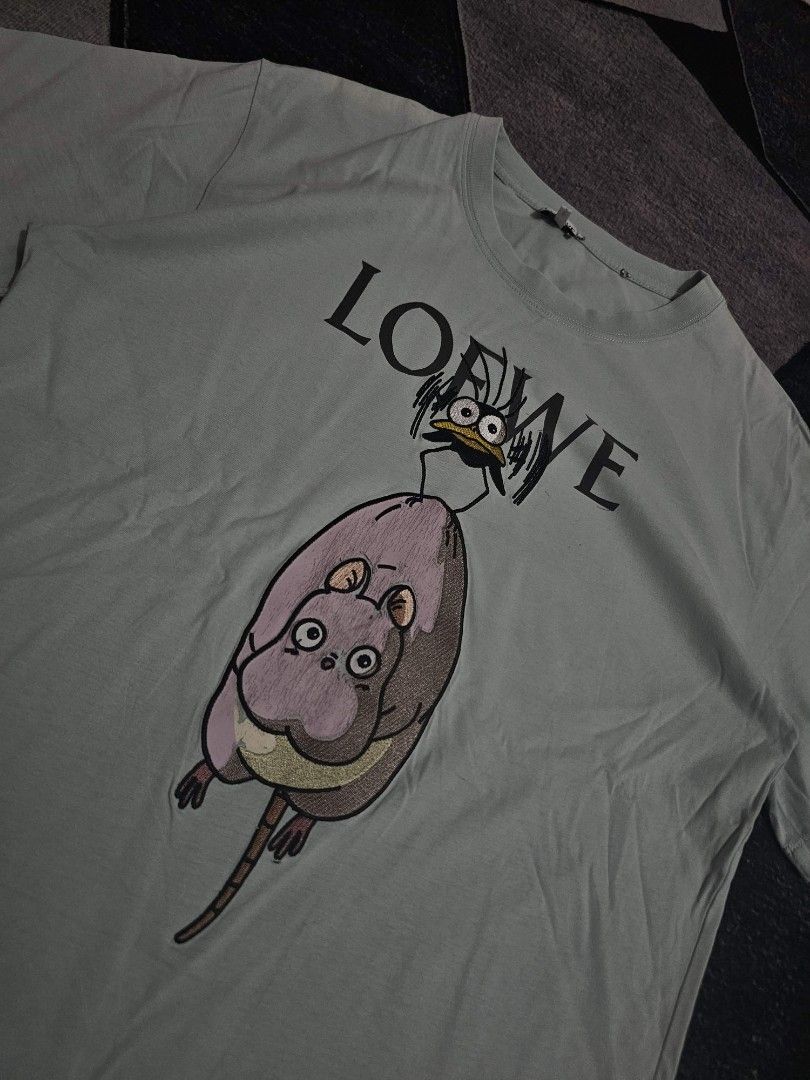 Loewe x Spirited Away T-shirt (Category: Tshirts & Polo Shirts ) located in Manila. Submitted by tobias_7795 (Listing ID 1432176040, Image 2). Description: - Loewe T-shirt - Light green color - Crew neck - Unique graphic print - Loewe logo on front - Unworn condition - Tag still attached.