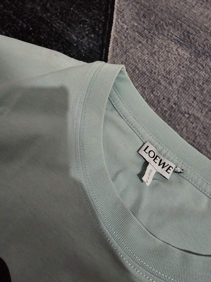 Loewe x Spirited Away T-shirt (Category: Tshirts & Polo Shirts ) located in Manila. Submitted by tobias_7795 (Listing ID 1432176040, Image 3). Description: - Loewe T-shirt - Light green color - Crew neck - Unique graphic print - Loewe logo on front - Unworn condition - Tag still attached.