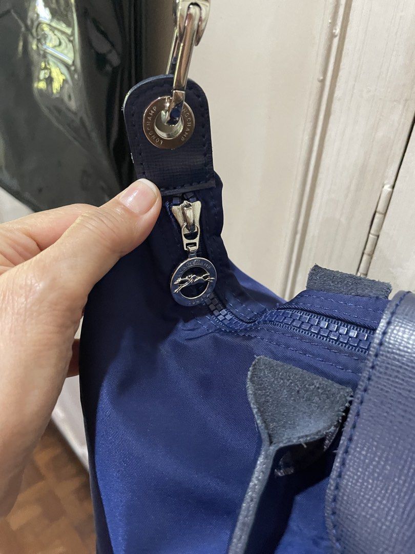 ORIGINAL Longchamp Le Pliage Shoulder Bag - Navy (Category: Luxury Bags & Wallets) located in Quezon City. Submitted by deadmit (Listing ID 1432050607, Image 3). Description: - Navy blue Longchamp Le Pliage shoulder bag - Flap closure with snap button - Detachable shoulder strap - Top handle - Zipper closure - Spacious interior - Silver-toned hardware - Longchamp logo visible.