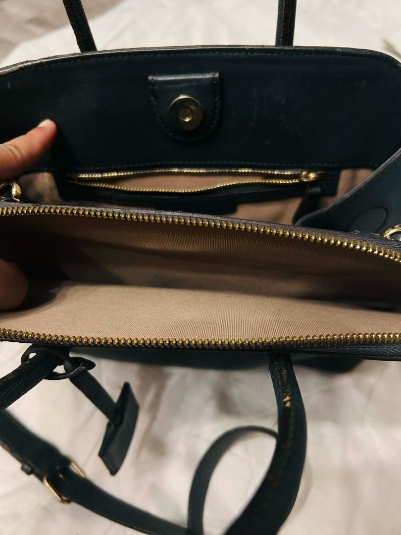 Louis Quatorze Black Handbag (Category: Luxury Bags & Wallets) located in Batangas. Submitted by selahs-closet (Listing ID 1432161989, Image 3). Description: Black handbag from Louis Quatorze. Features a top handle design with a zip closure. Includes a small tag and gold-toned hardware. The interior has a zip pocket..