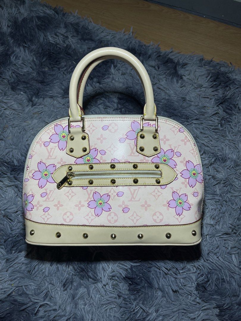Louis Vuitton Alma Handbag (Category: Luxury Bags & Wallets) located in Bislig. Submitted by cosmic_kylethrift (Listing ID 1432045023, Image 1). Description: - Louis Vuitton Alma handbag - Adorned with a delightful pink cherry blossom design - Features a comfortable top handle - Secure zip closure - Elegant gold-tone hardware - Interior lined with light beige suede - Made in France.