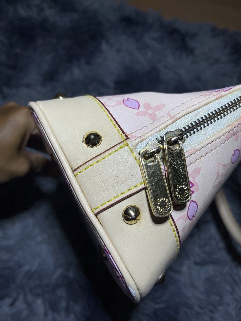 Louis Vuitton Alma Handbag (Category: Luxury Bags & Wallets) located in Bislig. Submitted by cosmic_kylethrift (Listing ID 1432045023, Image 2). Description: - Louis Vuitton Alma handbag - Adorned with a delightful pink cherry blossom design - Features a comfortable top handle - Secure zip closure - Elegant gold-tone hardware - Interior lined with light beige suede - Made in France.