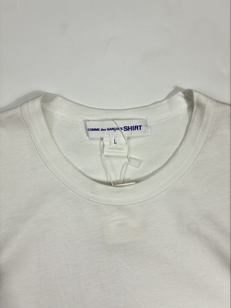 Made in Japan - Comme des Garcons Logo Shirt (Category: Tshirts & Polo Shirts ) located in Quezon City. Submitted by selling2survive (Listing ID 1432183993, Image 3). Description: Comme des Garçons Shirt Logo T-Shirt in white. This piece is typically crafted from 100% cotton jersey, providing breathability and comfort. Size: Large Length: 30 Pit to pit: 20.5 Shoulder: 18 Minor dirt stain only (Washable) .