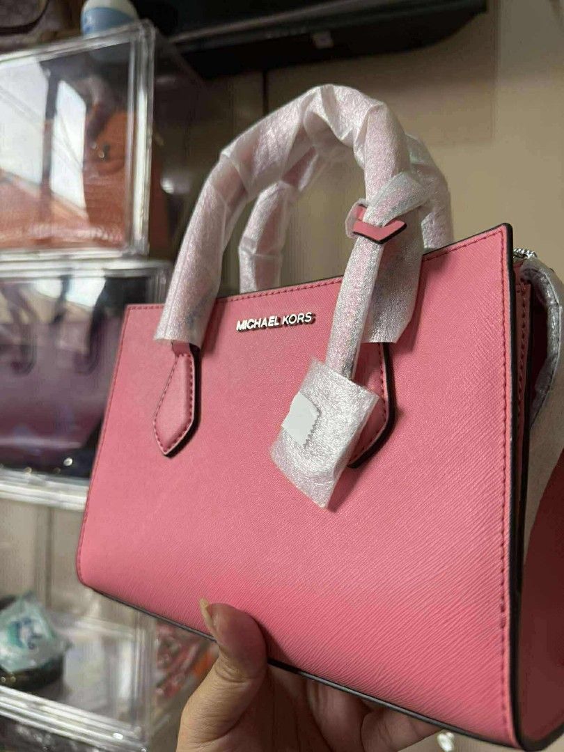 Michael Kors Pink Handbag (Category: Luxury Bags & Wallets) located in Macabebe. Submitted by itsuntameable24 (Listing ID 1432165206, Image 2). Description: - Brand new Michael Kors handbag - Eye-catching vibrant pink color - Stylish top handle design - Includes original tag - Unused and still in protective packaging - Features the iconic Michael Kors logo.
