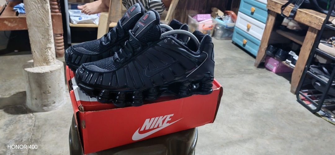 Nike Shox Black Sneakers (Category: Sneakers) located in Paranaque City. Submitted by GadgetAddicted (Listing ID 1432011322, Image 3). Description: - Black Nike Shox sneakers - Includes original red Nike box - Unique cushioned sole - Nike logo visible.