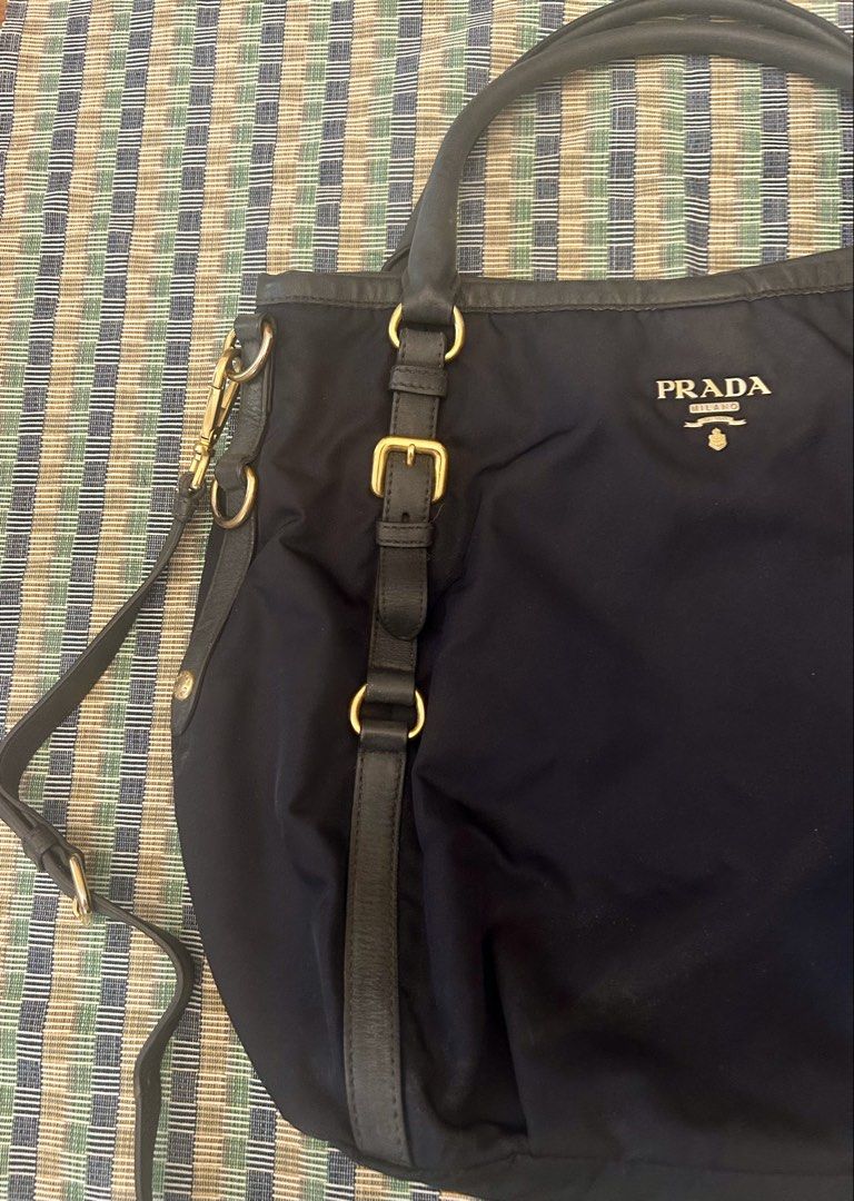 Prada Navy Blue Handbag with Shoulder Strap (Category: Luxury Bags & Wallets) located in Las Pinas. Submitted by tinamontec00246 (Listing ID 1432087213, Image 2). Description: 👜 Prada Tessuto Nylon 2-Way Bag – Blue | Authentic A timeless piece from Prada, crafted in the brand’s iconic Tessuto nylon — known for being lightweight, durable, and effortlessly elegant. This versatile bag can be worn handheld or crossbody, making it perfect for everyda