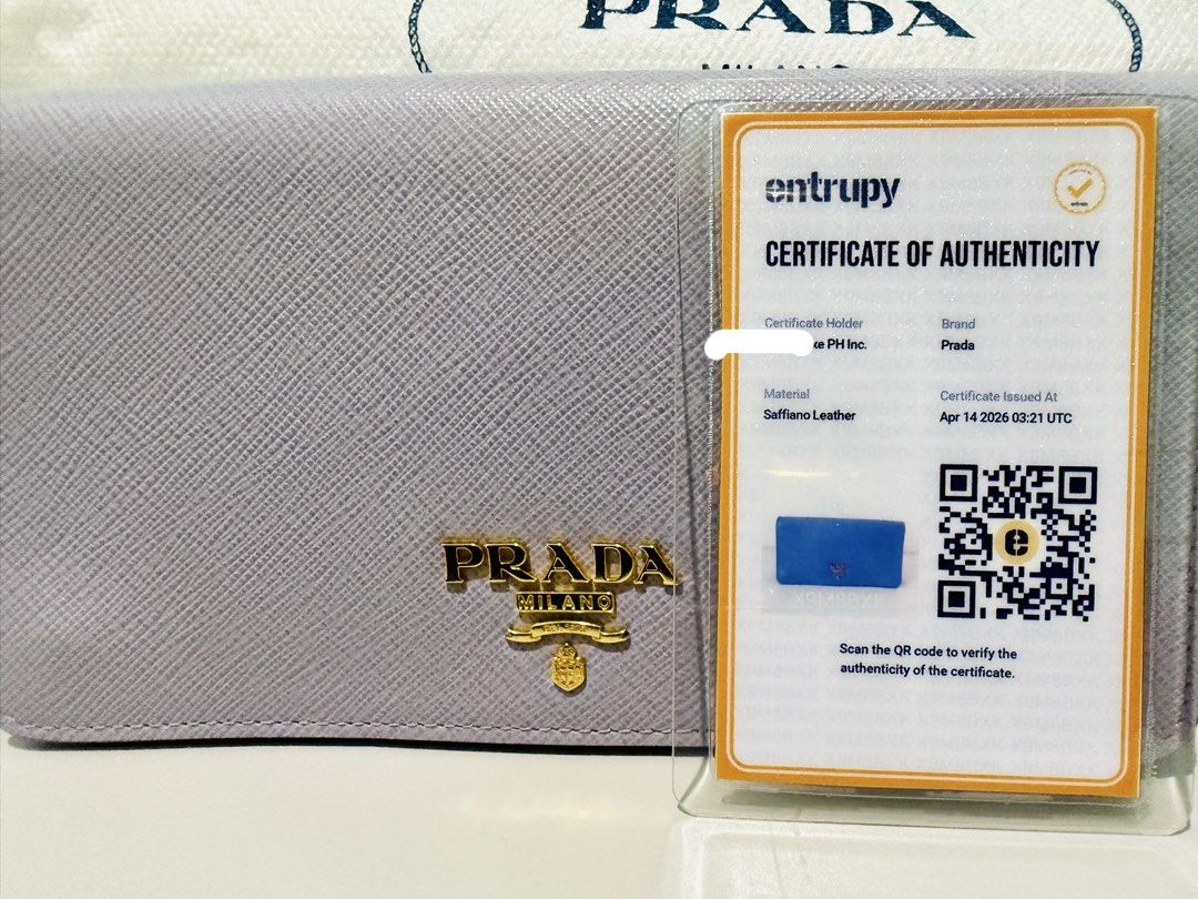 Prada Wallet on Chain w/ Card & Entrupy (Category: Luxury Bags & Wallets) located in Talisay. Submitted by justgeeeee (Listing ID 1431871659, Image 2). Description: - Authentic Prada Mini Bandolier Wallet - Light purple, Gold Hardware, Detachable Strap - Comes with original dust bag, card and entrupy Can fit Iphone Promax Can be worn 4 ways - crossbody, shoulder bag, kili bag, clutch/long wallet.