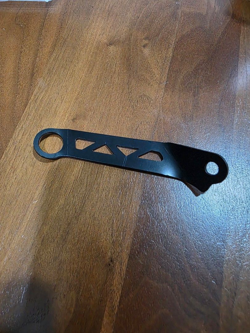 Right Side Bracket (Category: Motorcycle Accessories) located in Singapore. Submitted by seetv (Listing ID 1432192018, Image 2). Description: Brembo brake reservoir bracket. - Right side bracket. - Black color. - Metal construction. - Features a unique cutout design. Self collect at ANCHORVALE CRESCENT..