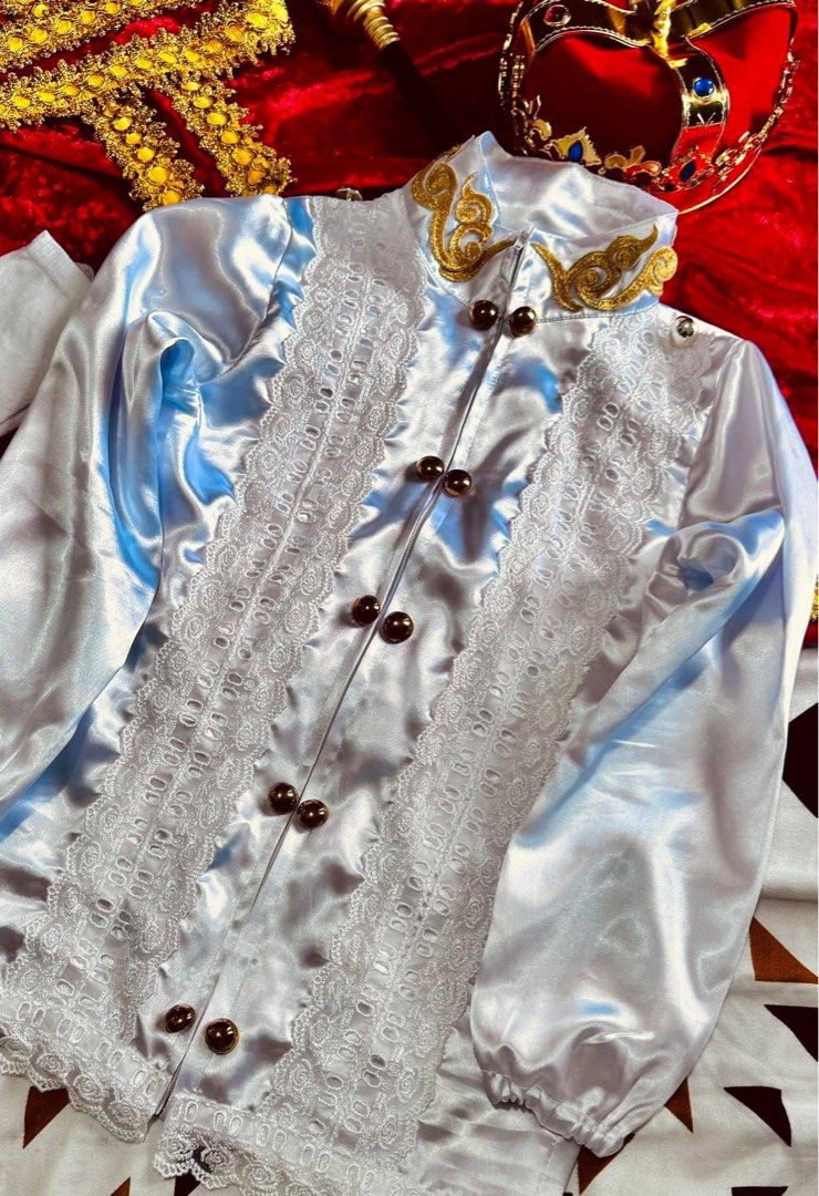 Royal Prince Costume Set (Category: Babies & Kids Fashion) located in Caloocan City. Submitted by genobatakatrina29-60657 (Listing ID 1432111006, Image 3). Description: - Royal Prince Costume Set for Boys for rent 7-10 y/o - Includes: White satin shirt with gold accents and lace details, matching pants, red cape, crown, scepter, and red sash with jewel. - Ideal for parades and themed events. - Designed for young boys..
