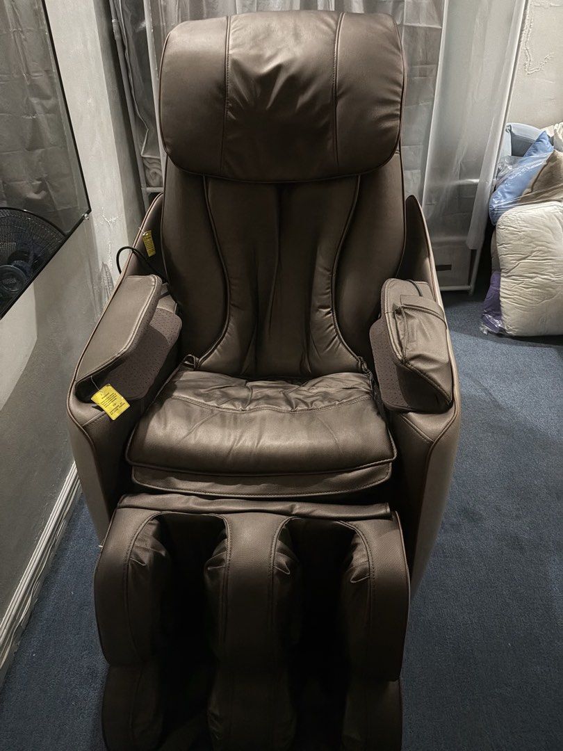 RUSH Ogawa Smart Vogue Massage Chair (Category: Massage Devices) located in Las Pinas. Submitted by tbclo (Listing ID 1431297180, Image 3). Description: - Ogawa massage chair - Color scheme: Brown and cream - Quilted backrest and seat - Includes footrest - Armrests with control panels - Made of leather or similar material - Modern design.