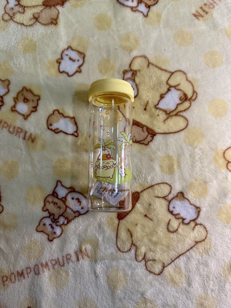 Sanrio Pompompurin glass Water Bottle (Category: Water Bottles & Tumblers) located in Makati City. Submitted by karabelle19923 (Listing ID 1432196546, Image 3). Description: - Brand new Pompompurin water bottle. - Features a fun tropical vacation design. - Clear body with measurement markings. - Comes with a yellow lid. - Decorated with palm trees and musical notes. - Includes original packaging. - official miniso item.