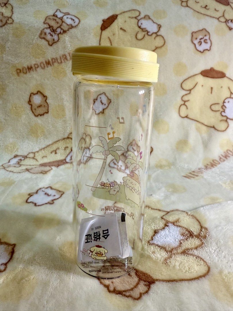 Sanrio Pompompurin glass Water Bottle (Category: Water Bottles & Tumblers) located in Makati City. Submitted by karabelle19923 (Listing ID 1432196546, Image 2). Description: - Brand new Pompompurin water bottle. - Features a fun tropical vacation design. - Clear body with measurement markings. - Comes with a yellow lid. - Decorated with palm trees and musical notes. - Includes original packaging. - official miniso item.