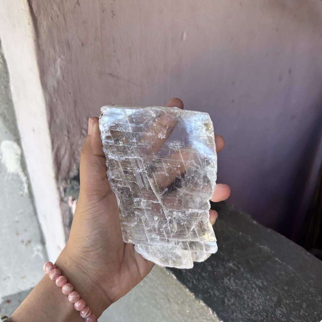 Selenite Crystal with Wooden Stand (Category: Precious Stones) located in Rizal. Submitted by kaycewanders (Listing ID 1432020234, Image 2). Description: - Translucent selenite crystal - Includes a dark wooden stand - Features natural lines and textures - Substantial size, fits in one hand - Light, neutral color - Stable base provided by the stand Selenite Slab with stand 1000 Loc: Montalban Mop: Gcash/metrobank Mod: Jnt.