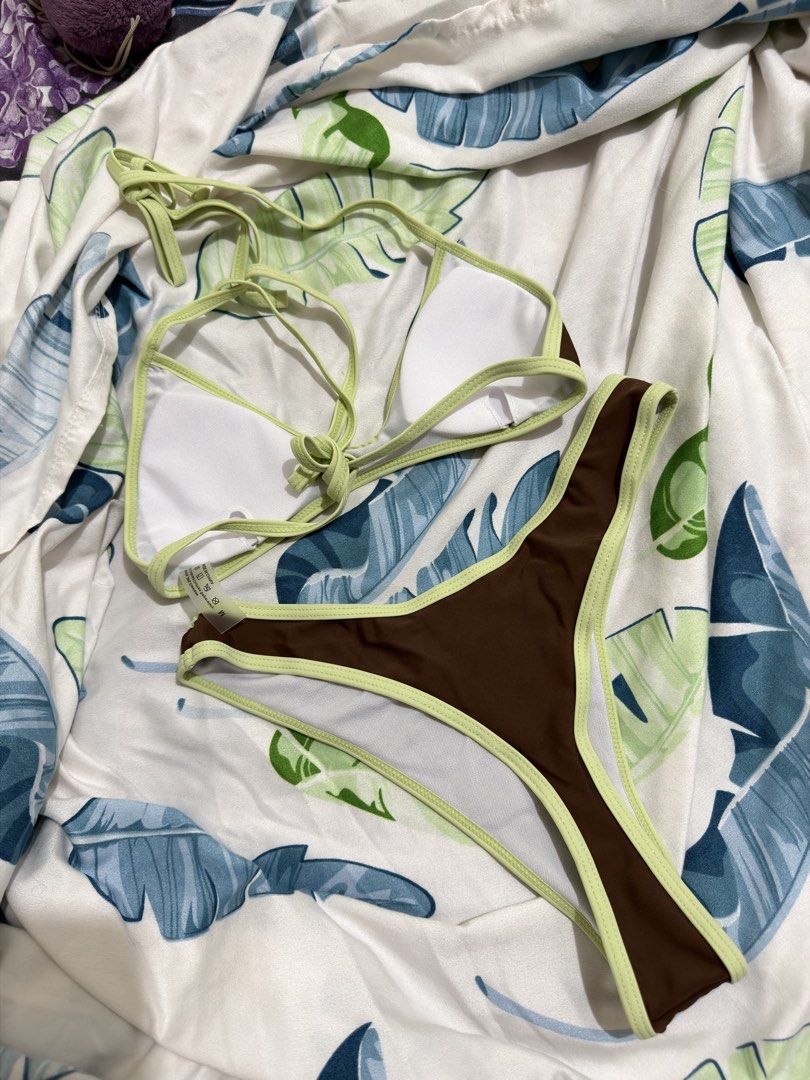 Shein Two Piece Bikini Set (Category: Bikinis & Swimsuits) located in Makati City. Submitted by sofiaannedvr (Listing ID 1432160162, Image 2). Description: - Brown bikini with green trim - Adjustable straps for a comfortable fit - Made of smooth material - Medium on tag but can fit Small sized girlies - Classic and chic design -RFS: A little bit small for me (as a medium sized girlie) -Never been used.