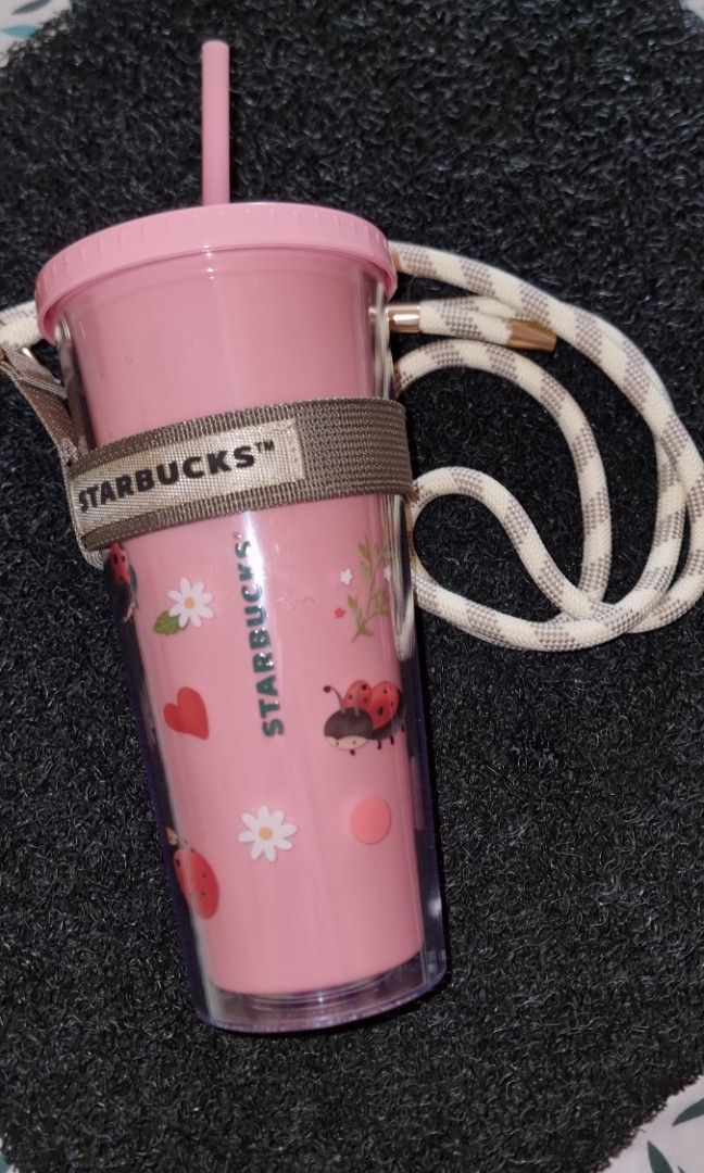 Starbucks 22oz Love Bug Cold Cup with Strap LoveBug Collection (Category: Water Bottles & Tumblers) located in Cebu City. Submitted by McCroix (Listing ID 1432143109, Image 2). Description: Starbucks 22oz Love Bug Cold Cup with Strap LoveBug Collection NOTE : strap holder is not pink its a gray/ kinda dark pink see picture for reference Description and Features: •Color Palette: The primary body features a soft, pastel "Millennial Pink" or "Petal 