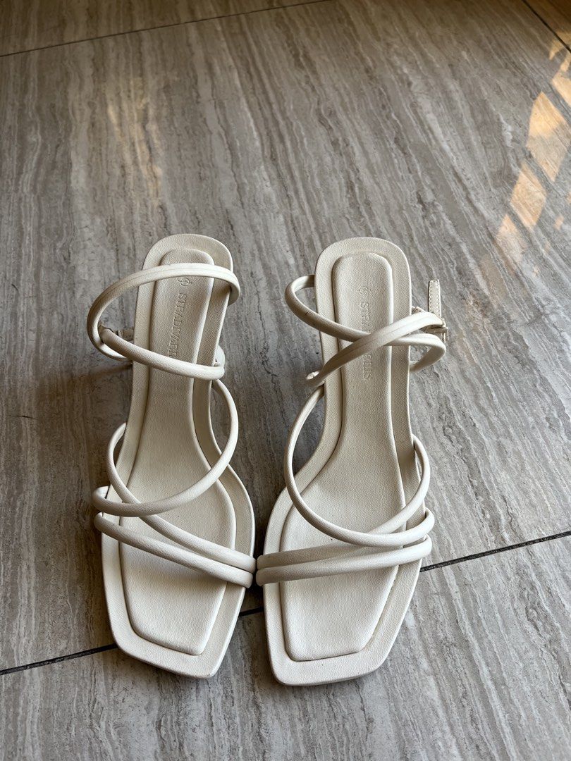 Stradivarius White Strappy Heels (Category: Heels) located in Cavite. Submitted by letsgosab (Listing ID 1432196101, Image 1). Description: - Stradivarius white strappy heels - Square toe design - Delicate ankle strap - Unique curved heel - Comfortable and stylish - Perfect for casual or dressy outfits.