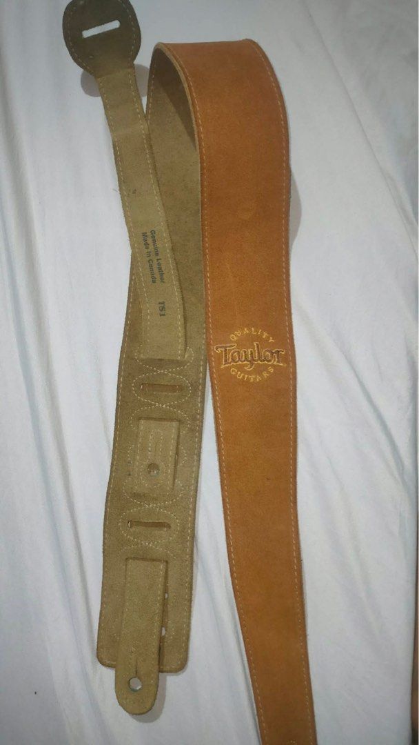 Taylor Guitar Strap - Genuine Leather (Category: Musical Instruments) located in Dagupan City. Submitted by oompph (Listing ID 1432088227, Image 2). Description: - Genuine leather guitar strap from Taylor Guitars - Tan suede finish - Features Taylor Guitars logo embroidery - Adjustable length - Made in Canada - Classic design - Suitable for various guitar types.