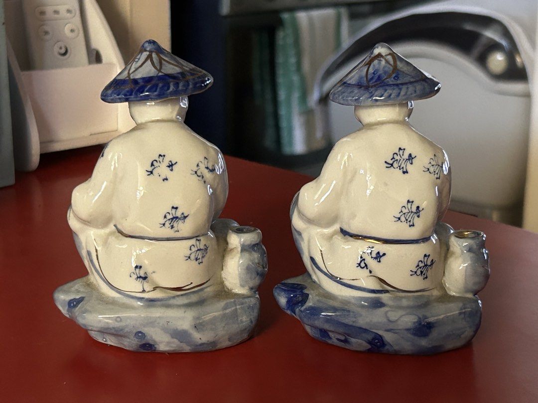 Vintage Fisherman Figurines (Category: Figurines & Statues) located in Las Pinas. Submitted by rjmwings (Listing ID 1432137359, Image 2). Description: Pair of vintage figurines depicting fishermen. Bought in 2005. They are wearing blue and white robes and conical hats. Each figurine is seated on a base with fish. The figurines have gold accents. The backs of the figurines have floral patterns. Made of ceramic. Being sold as a pair.
