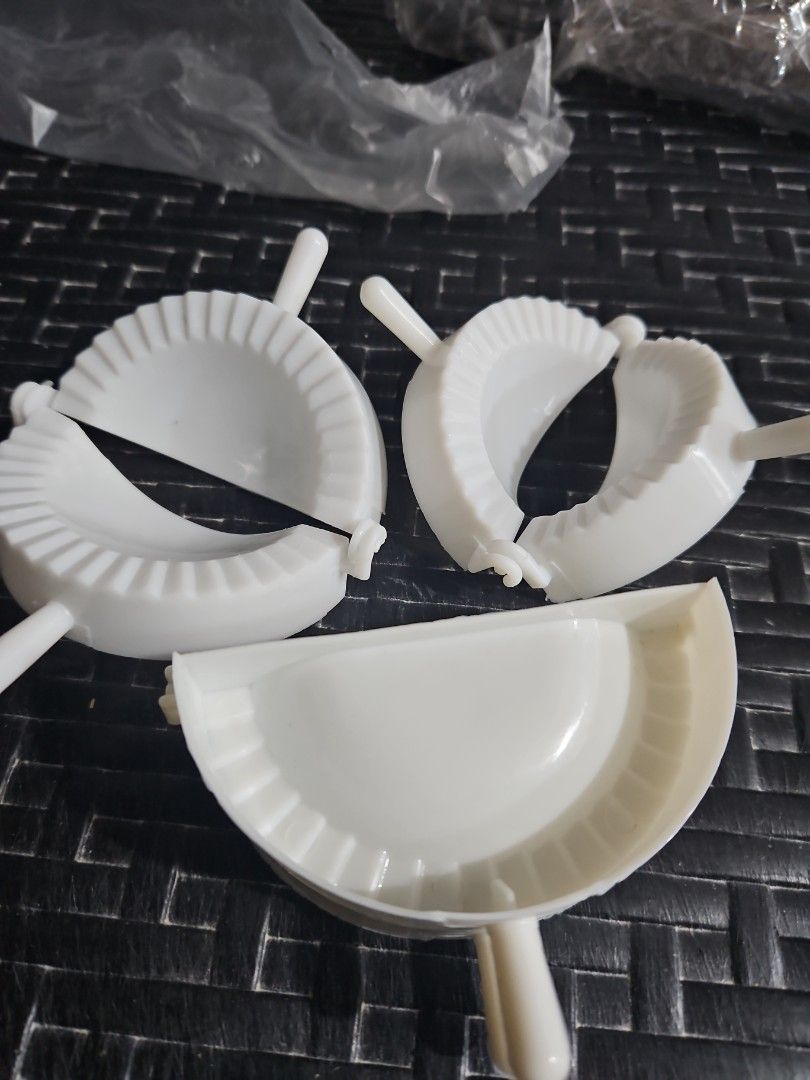 White Dumpling Maker (Category: Bakeware) located in Manila. Submitted by just_about_anything (Listing ID 1432127208, Image 1). Description: - Easy dumpling making set - Made of durable white plastic - Includes multiple pieces for efficient use - Features a convenient handle - Creates dumplings with a crimped edge for perfect sealing.