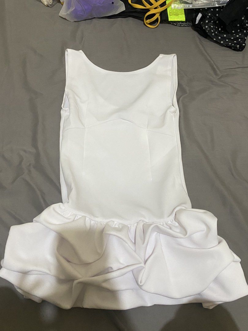White Ruffle Hem Dress (Category: Dresses) located in Manila. Submitted by dodoheeee (Listing ID 1432159112, Image 2). Description: - White sleeveless dress - Features a flattering ruffle hem - Fitted bodice and scoop neckline - Ideal for special occasions and nights out - Made of smooth, likely synthetic fabric - Simple and chic design.