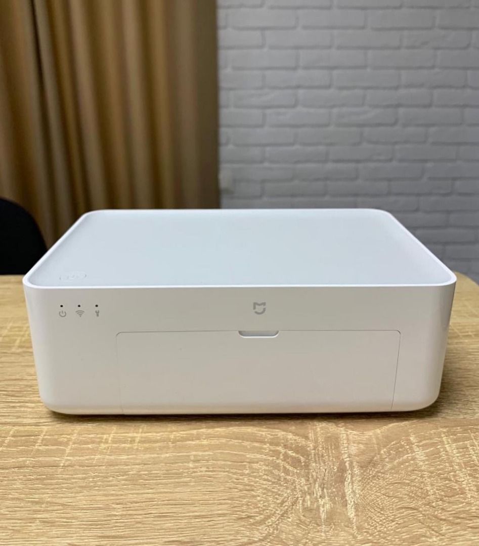 Xiaomi Mi Portable Photo Printer (Category: Printers, Scanners & Copiers) located in Caloocan City. Submitted by truehawk.889b68 (Listing ID 1432034050, Image 2). Description: Xiaomi Mi Portable Photo Printer. It has a sleek white design with a small drawer for photo output. The printer has a power button and indicator lights for power, Wi-Fi, and USB connectivity..