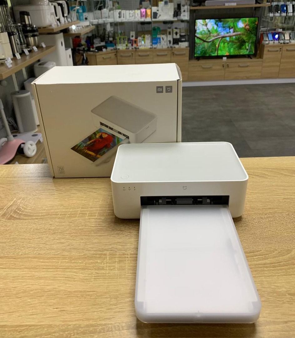 Xiaomi Mi Portable Photo Printer (Category: Printers, Scanners & Copiers) located in Caloocan City. Submitted by truehawk.889b68 (Listing ID 1432034050, Image 1). Description: Xiaomi Mi Portable Photo Printer. It has a sleek white design with a small drawer for photo output. The printer has a power button and indicator lights for power, Wi-Fi, and USB connectivity..