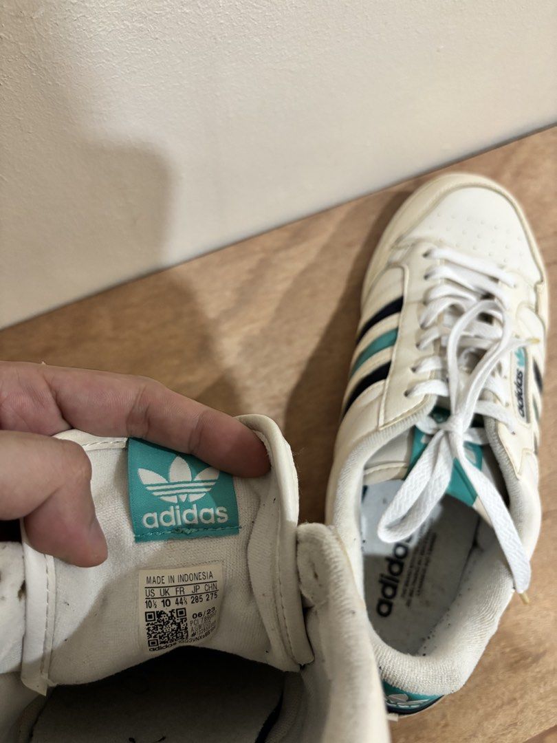 Adidas Continental 80s White Sneakers (Category: Sneakers) located in Bacoor. Submitted by palmroot (Listing ID 1432245033, Image 3). Description: - Adidas Continental 80s - White with teal and black stripes - Adidas logo on tongue and heel - Size: US 10 / UK 9.5 / FR 44 / JP 285 - Made in Indonesia - White laces and sole - has fabric rubs on inner later from black socks but kept clean and minimally used.