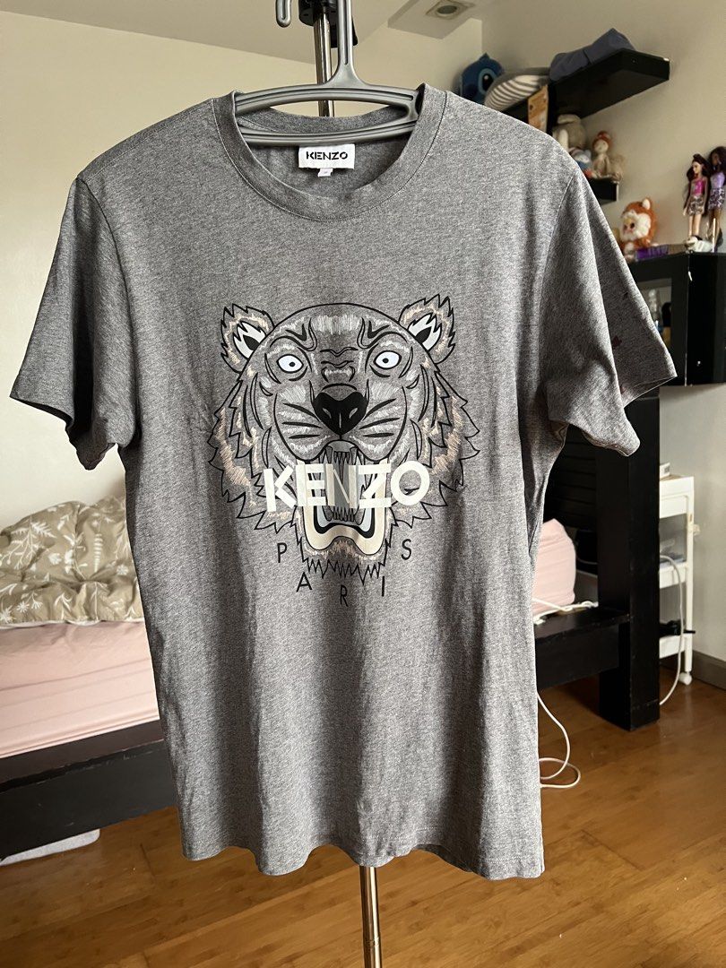 (Authentic) Kenzo Paris Tiger Shirt (Category: Luxury Apparel) located in Cavite. Submitted by kumbin (Listing ID 1432384492, Image 2). Description: Kenzo Shirt (100% legit) Bought from Good Goods V2 so we can guarantee the authenticity Dimensions: 18.5 by 26.5 (S on tag) Issue: Good as new sana, kaso may small stain sa sleeve (last pic) Color rate: 10/10 like new 🔥 Condition: 9/10 great +sf Shipping via J&T.