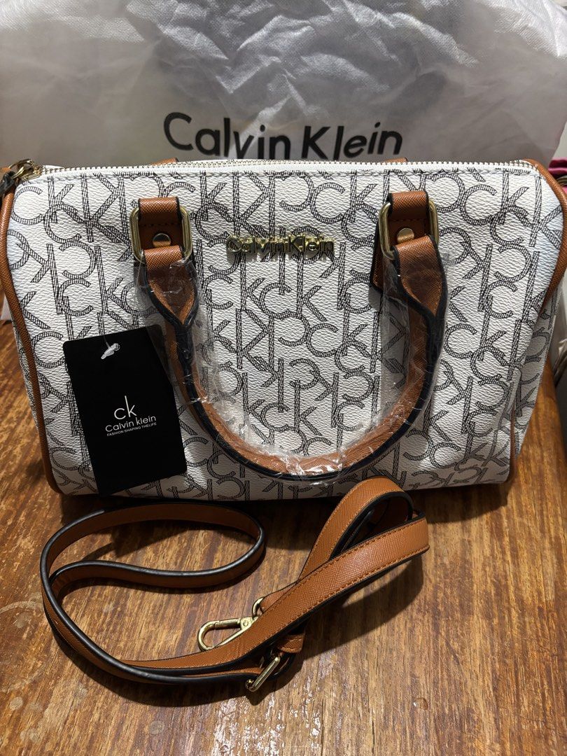 Calvin Klein Monogram Doctors Bag (Category: Luxury Bags & Wallets) located in Caloocan City. Submitted by trendycityph (Listing ID 1432273406, Image 1). Description: Color: White With detachable shoulder strap With dust bag Brand new Loc: C3 Caloocan (South).