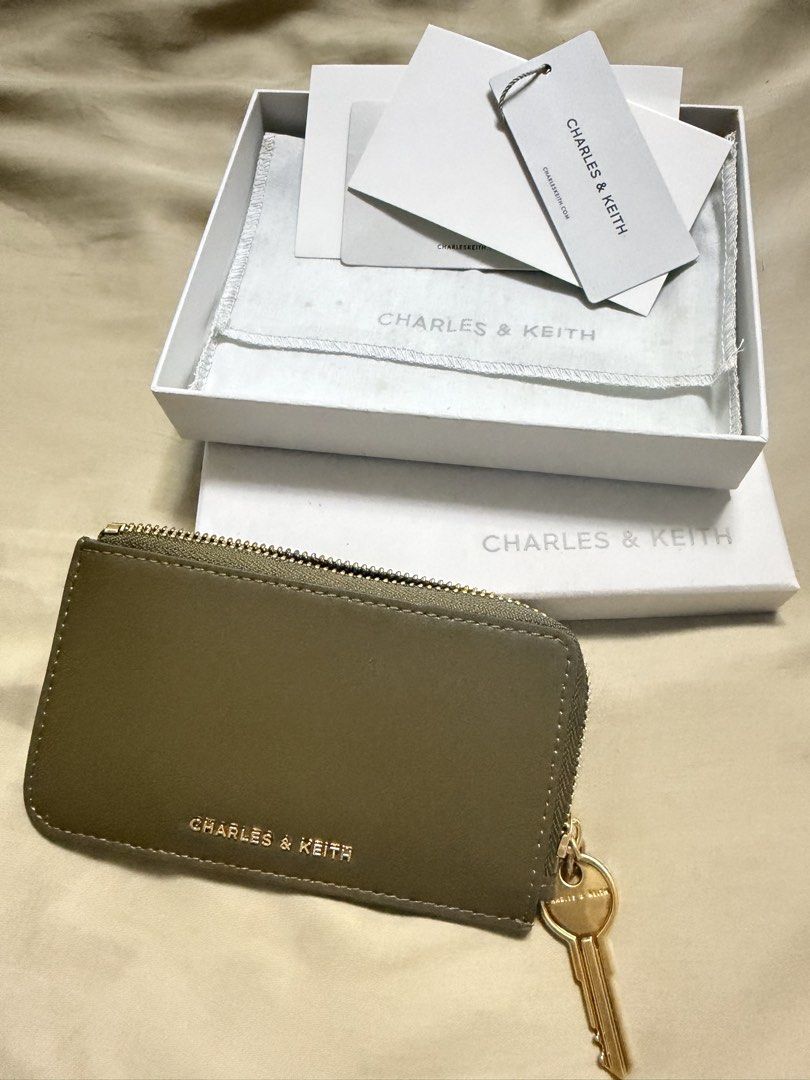 Charles & Keith Zip-around Wallet (Category: Wallets & Card holders) located in Manila. Submitted by mal.eficent (Listing ID 1432312579, Image 1). Description: Charles & Keith Zip-around Wallet Color: Olive With box & dustbag Tags cut but never used. 🏖️This is already a bargain. Still selling @ 999. Grab this item now! Meetups in BGC. PIOG. #charles&keith #wallet #ziparound.