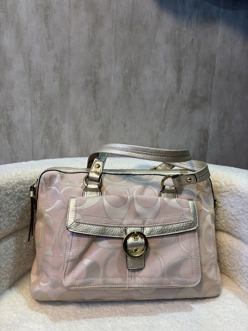 Coach Pink and Gold Satchel (Category: Luxury Bags & Wallets) located in Manila. Submitted by _thepursela (Listing ID 1432270451, Image 1). Description: - Authentic Coach handbag - Signature Coach pattern - Gold hardware accents - Secure top zipper closure - Front pocket with buckle - Double handles - Pink fabric lining - Metal feet at the bottom.