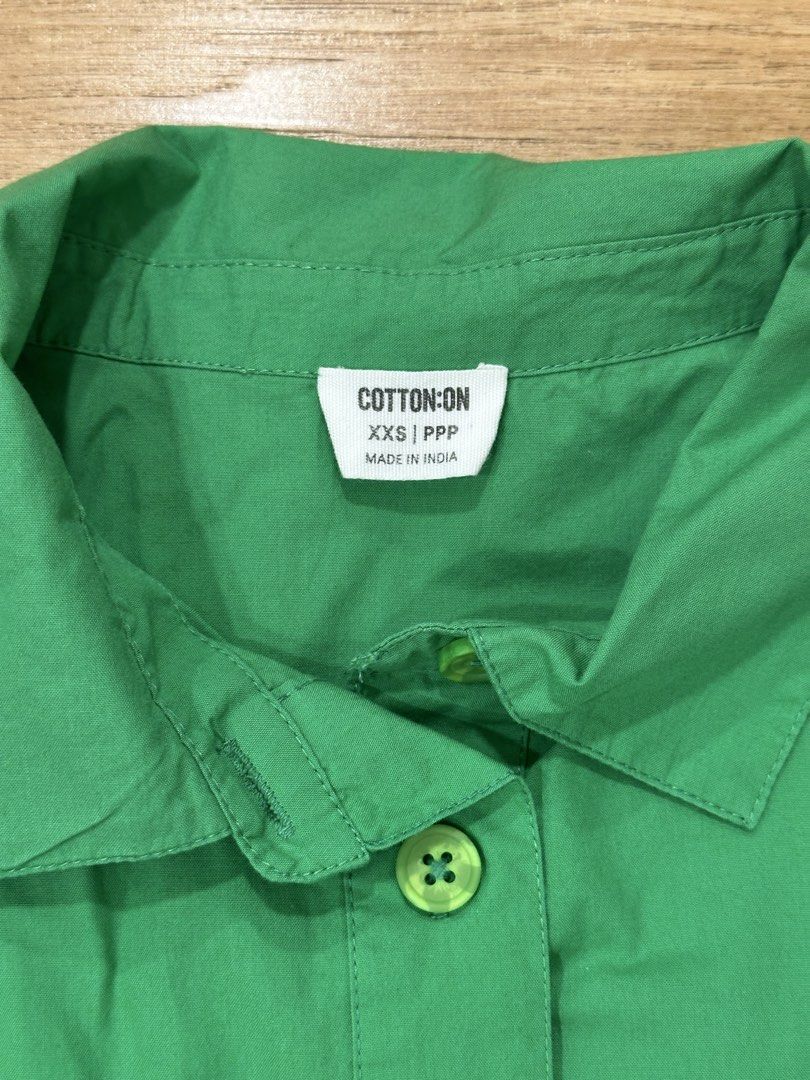 Cotton On Green Dress (Category: Dresses) located in Taguig. Submitted by fromtcloset (Listing ID 1432292545, Image 2). Description: - Cotton On green dress - Size: XXS-XS - Features: - Collared neckline - Button-down front - Short sleeves - Two chest pockets - Tiered skirt - Made in India.