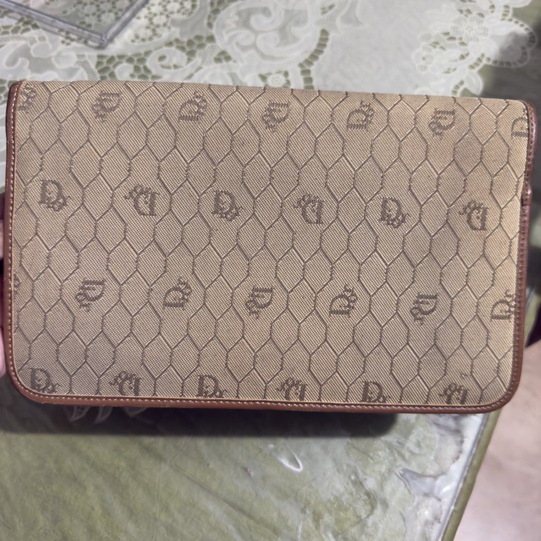 Dior Clutch Bag (Category: Luxury Bags & Wallets) located in Iloilo. Submitted by kristena87 (Listing ID 1432325154, Image 3). Description: - Authentic Dior clutch - Beige monogram pattern - Brown leather trim - Flap closure with circular logo - Multiple interior compartments.