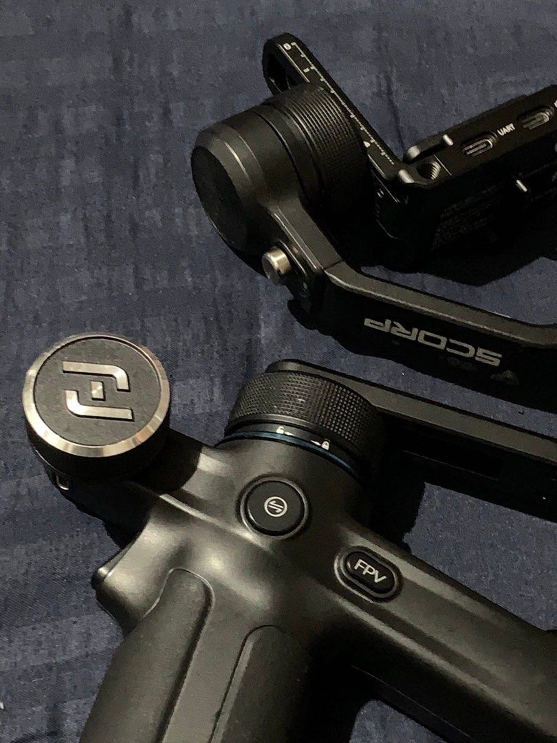 Feiyu SCORP-mini 3-Axis Handheld Gimbal (Category: Gimbals & Stabilizers ) located in Cavite. Submitted by huemiyohan (Listing ID 1432374408, Image 3). Description: - Feiyu SCORP-mini 3-Axis Handheld Gimbal for smartphones - FPV mode - Built-in screen for settings - Multiple ports (UART, USB-C) - Model: F1 - Black color - Handle with control buttons.