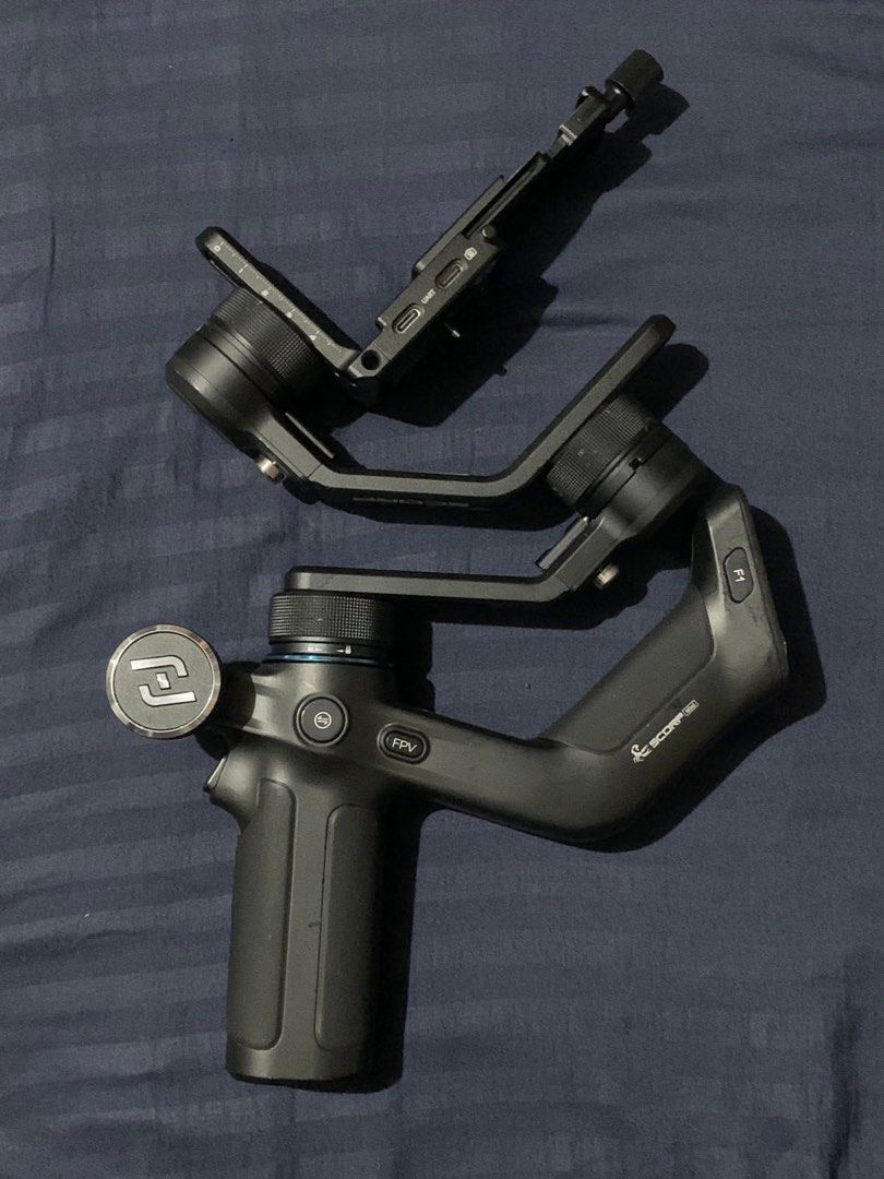Feiyu SCORP-mini 3-Axis Handheld Gimbal (Category: Gimbals & Stabilizers ) located in Cavite. Submitted by huemiyohan (Listing ID 1432374408, Image 1). Description: - Feiyu SCORP-mini 3-Axis Handheld Gimbal for smartphones - FPV mode - Built-in screen for settings - Multiple ports (UART, USB-C) - Model: F1 - Black color - Handle with control buttons.