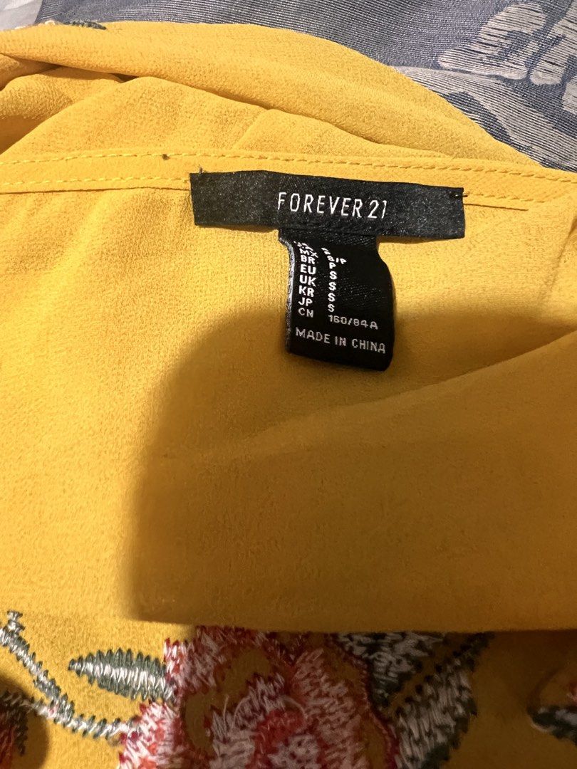 Forever 21 Embroidered Ruffle Sleeve Blouse (Category: Blouses) located in Quezon City. Submitted by fly29 (Listing ID 1432283483, Image 2). Description: - Forever 21 blouse - Vibrant yellow color - Floral embroidery - Ruffle sleeves - Lightweight design - Size: S - Perfect for adding a pop of color!.
