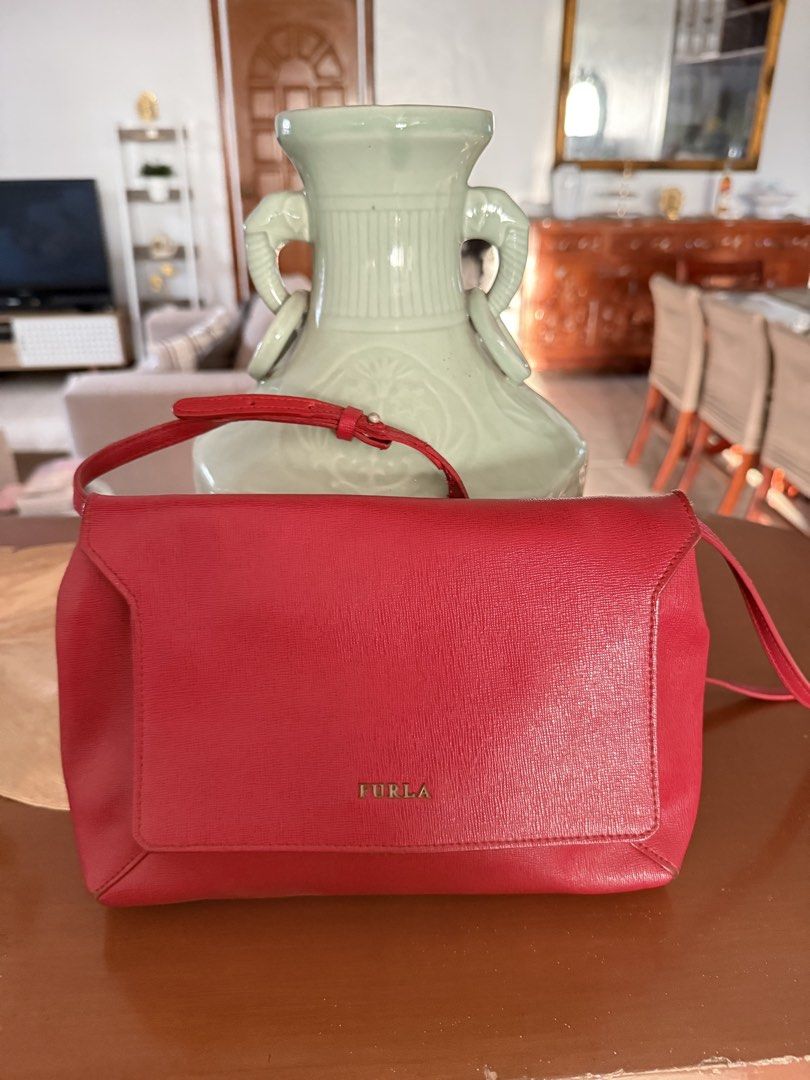 Furla Red Crossbody Bag (Category: Luxury Bags & Wallets) located in Quezon City. Submitted by myfavecloset11 (Listing ID 1432288591, Image 1). Description: - Red Furla crossbody bag - Flap closure with magnetic snap - Interior zippered pocket - Furla branded tag - Long, adjustable strap - w/ signs of wear on strap.