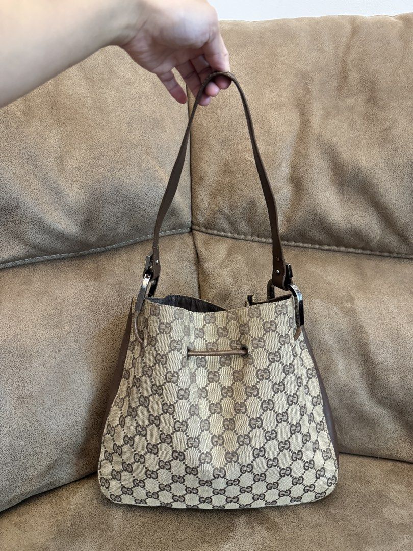 Gucci GG Canvas Bucket Bag (Category: Luxury Bags & Wallets) located in Manila. Submitted by mayserrano16 (Listing ID 1432374074, Image 2). Description: - Authentic Gucci bucket bag - Iconic GG canvas - Brown leather trim - Drawstring closure - Single handle - Fabric-lined interior - Interior zip pocket - Gucci logo visible - Made in Italy.